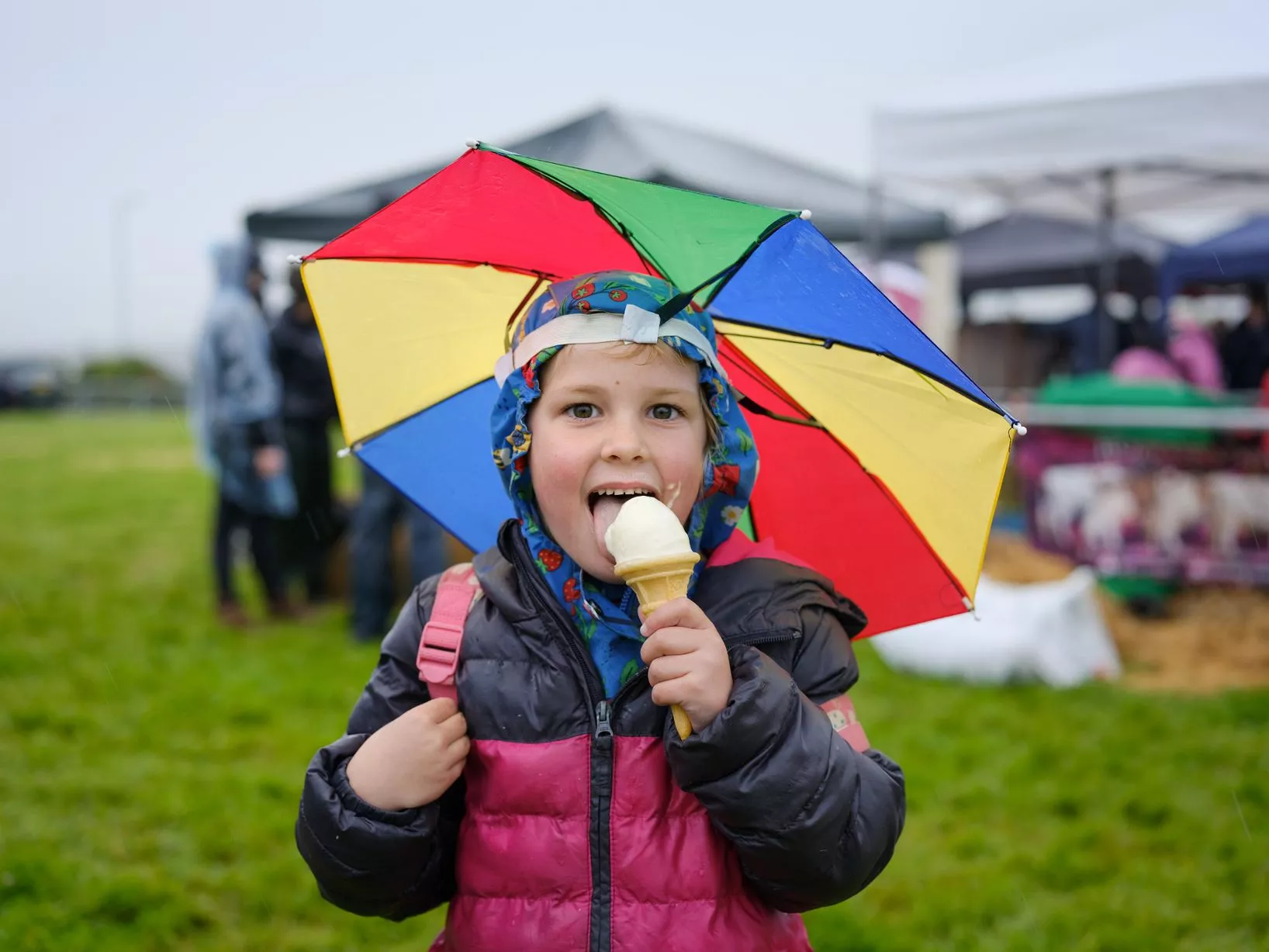 5-year-old Elowen enjoys an ice cream in the rain.